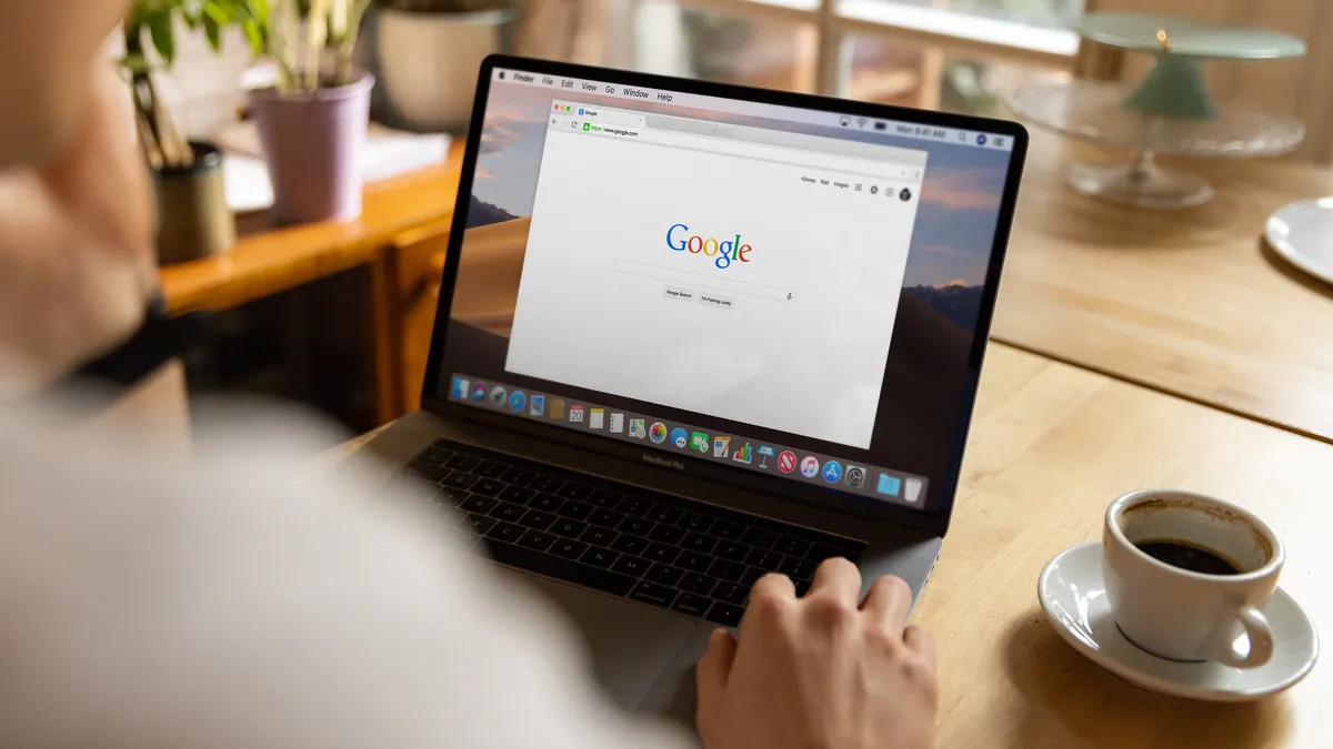 person using Google search on a laptop