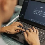 Person typing on laptop with AI chat interface