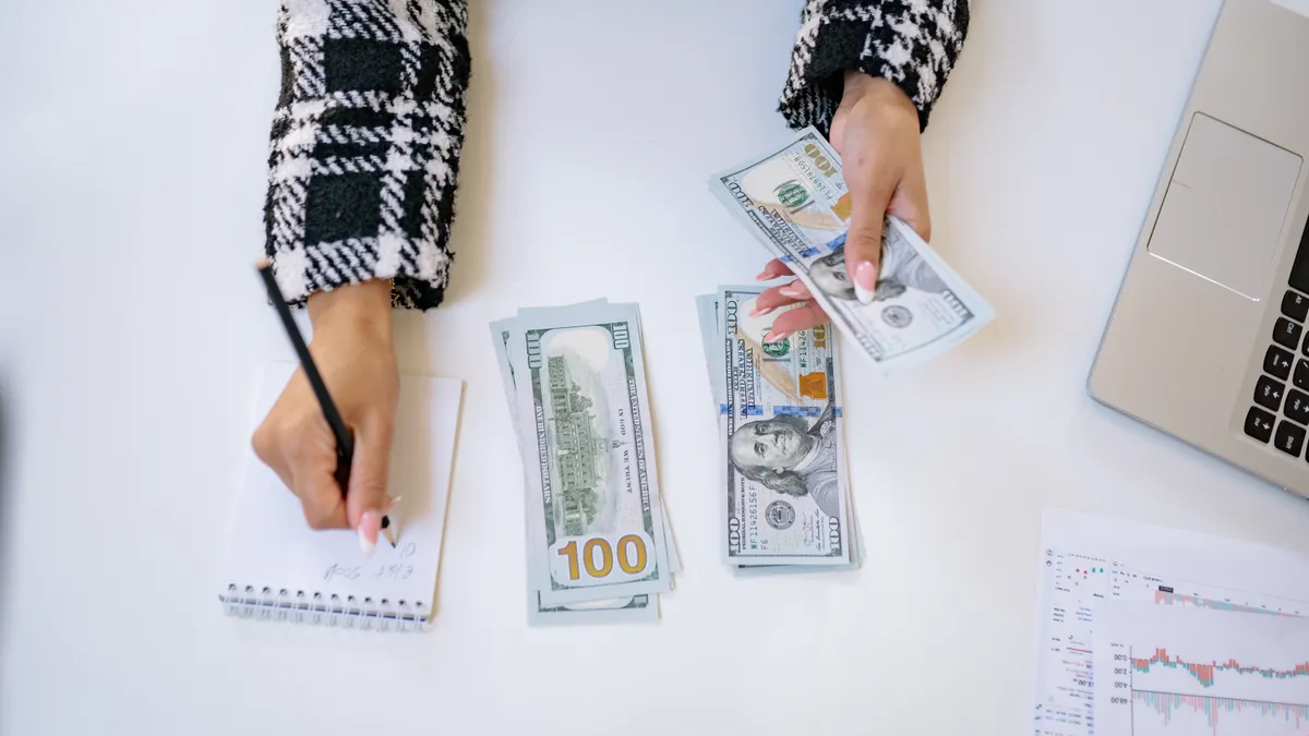 AI writing tools AI writing tools — A Person Taking Notes while Counting Money