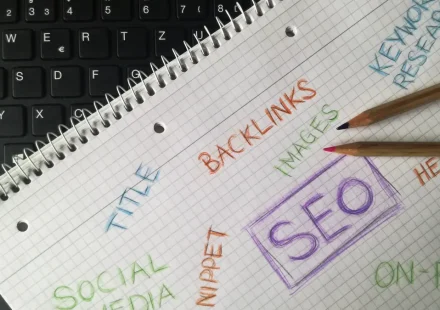 SEO notes on a notebook beside a keyboard