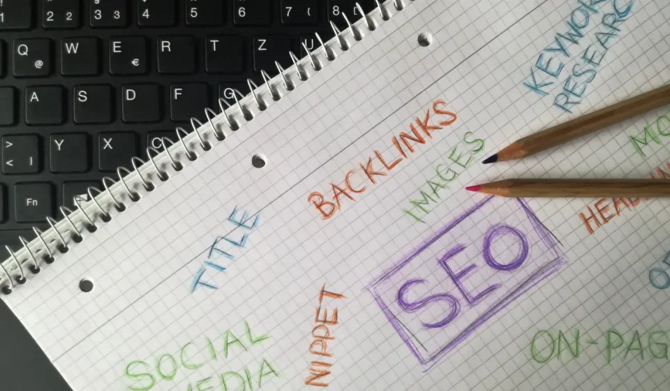 SEO notes on a notebook beside a keyboard