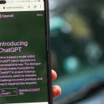 Hand holding a phone with ChatGPT open