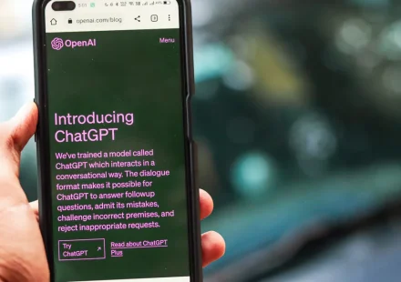 Hand holding a phone with ChatGPT open