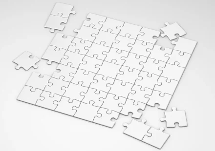 mostly assembled white jigsaw puzzle with a few loose pieces