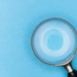 Magnifying glass on blue background