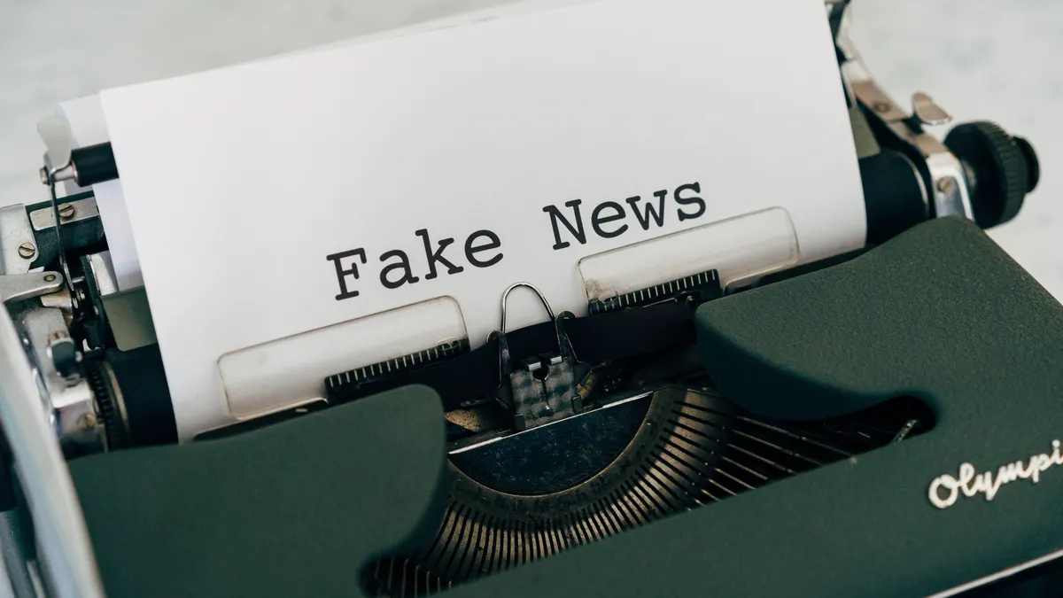 Typewriter with paper reading fake news