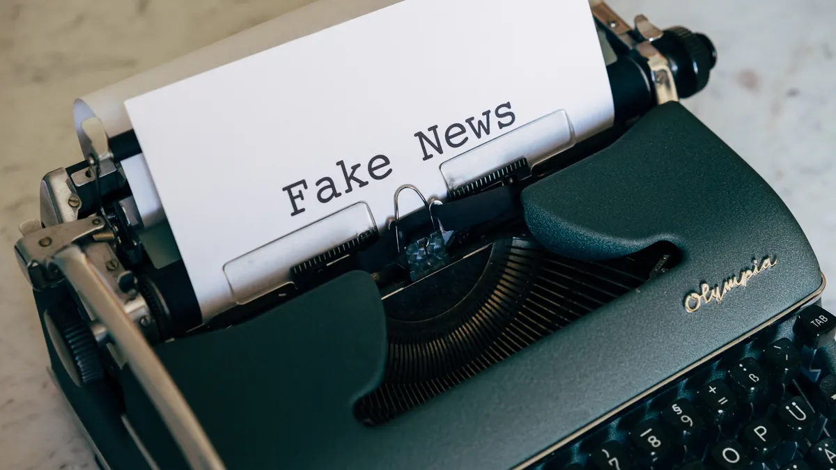 Typewriter with paper reading fake news